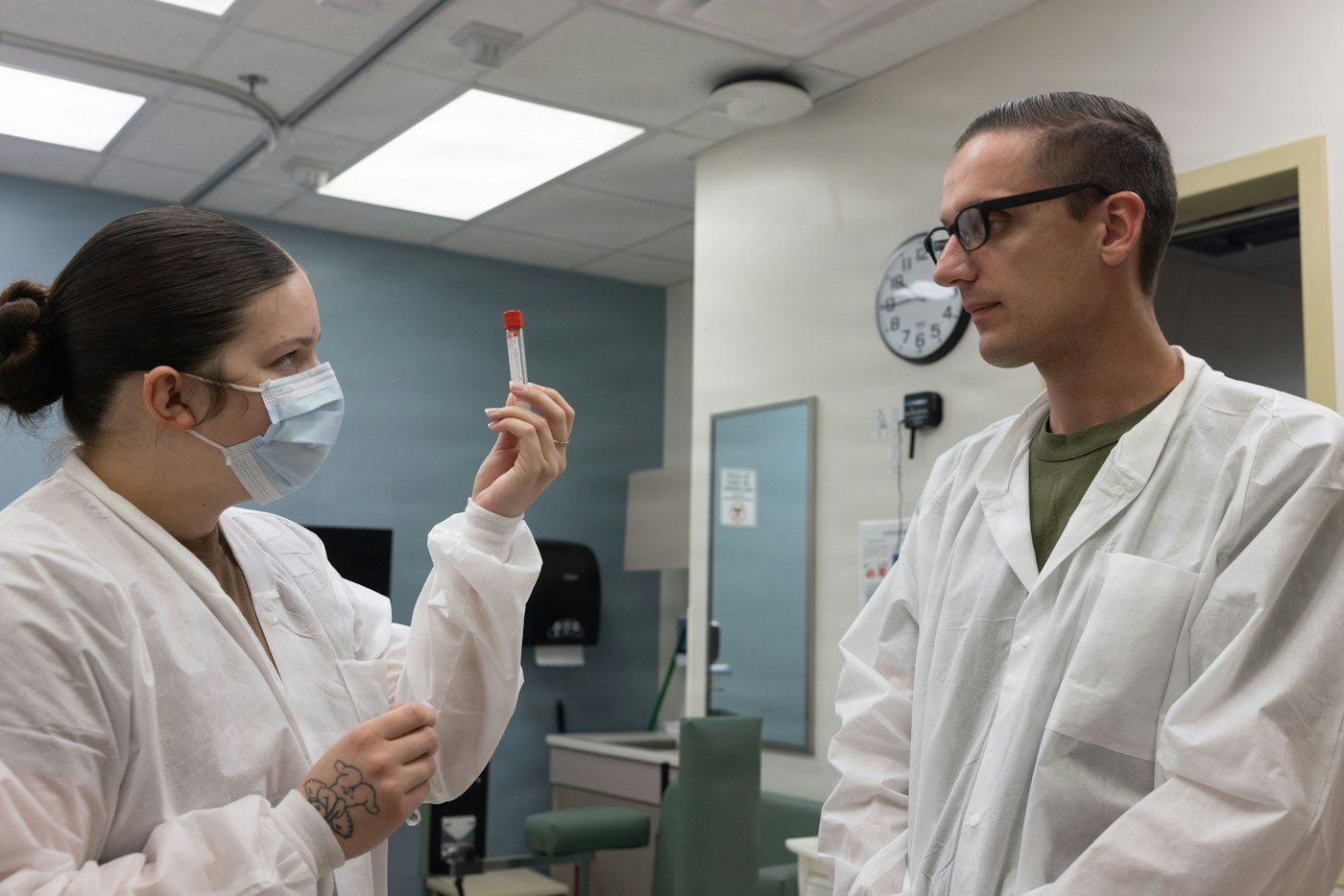 Two scientists discussing a sample in the laboratory