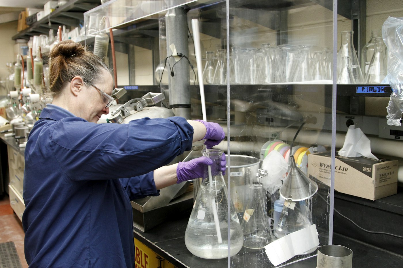 Scientist preparing solutions with laboratory glassware